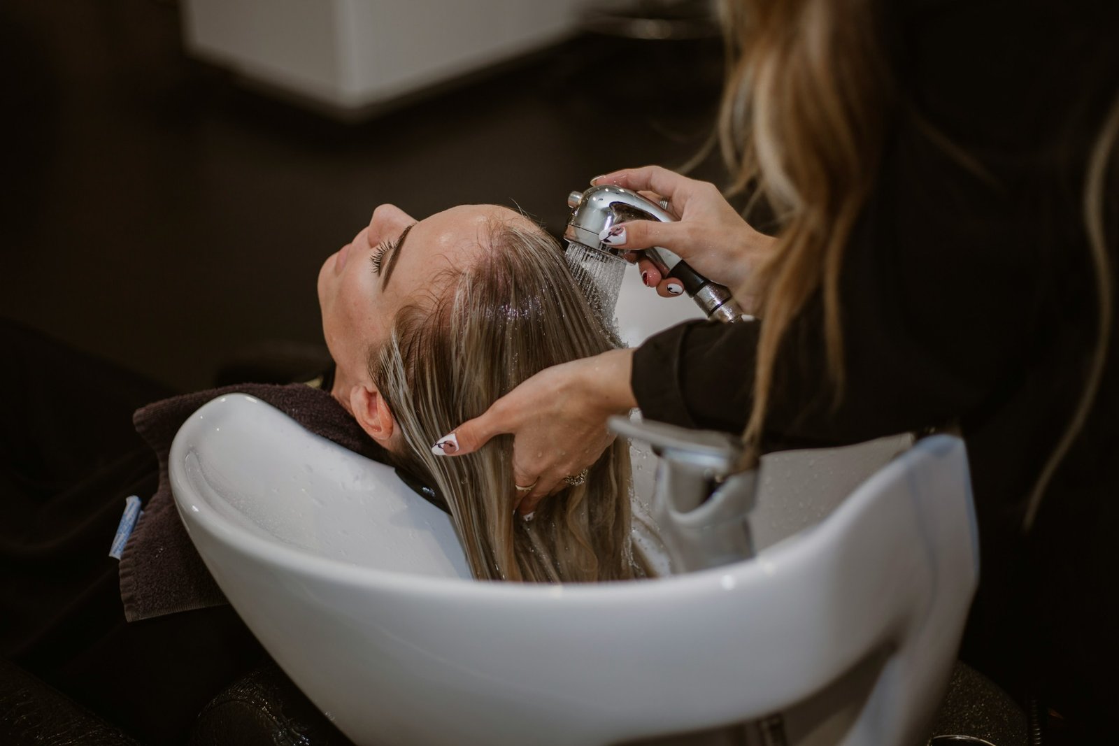 Lady getting her hair washed